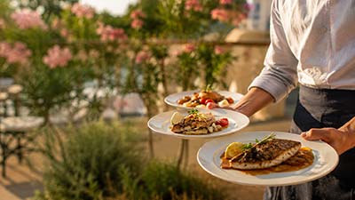 Service de plats gastronomiques sur la terrasse du restaurant Le Kallisté à Hyères dans une ambiance élégante et méditerranéenne
